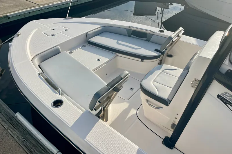 Slide: The Image of 2025 Robalo 226 Cayman boat interior with cushioned seating and storage compartments. - 5