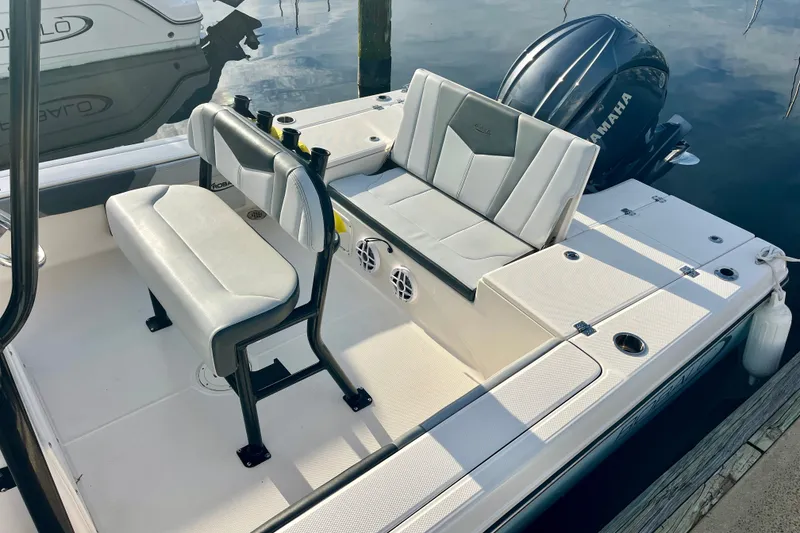 Slide: The Image of 2025 Robalo 226 Cayman boat interior with Yamaha engine, featuring cushioned seating and storage compartments. - 6