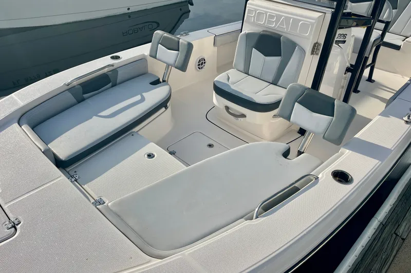 Slide: The Image of 2025 Robalo 226 Cayman boat interior with cushioned seating and sleek design. - 4