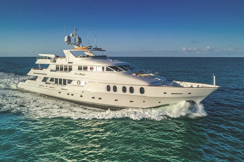 The Image of Luxurious 2002 Christensen Trideck yacht cruising on open ocean under clear blue sky. - 1