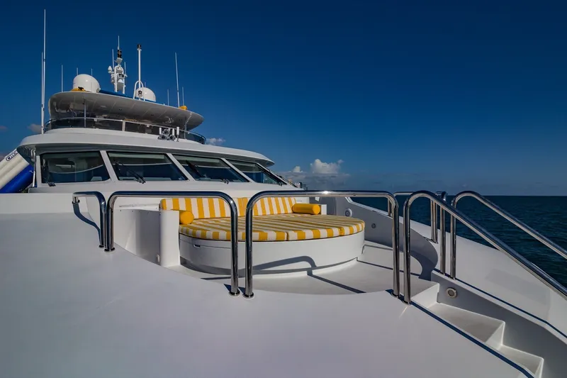 Slide: The Image of Luxurious 2002 Christensen Trideck yacht with striped seating, cruising under clear blue skies. - 42