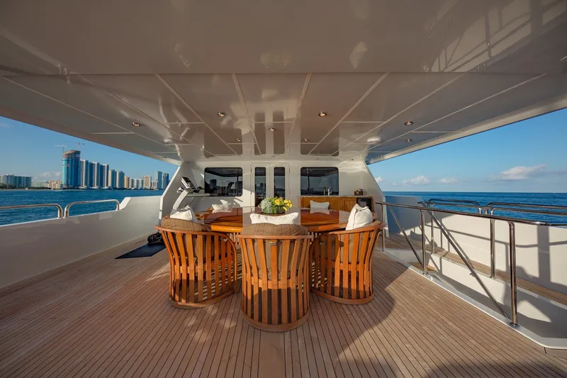 Slide: The Image of Luxurious 2002 Christensen Trideck yacht deck with elegant wooden seating and ocean view. - 52