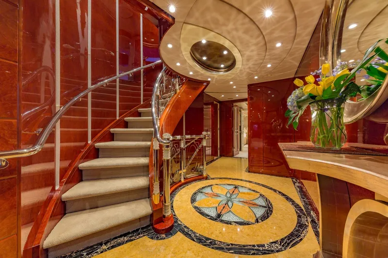 Slide: The Image of Luxurious interior of 2002 Christensen Trideck yacht with elegant staircase and floral arrangement. - 37