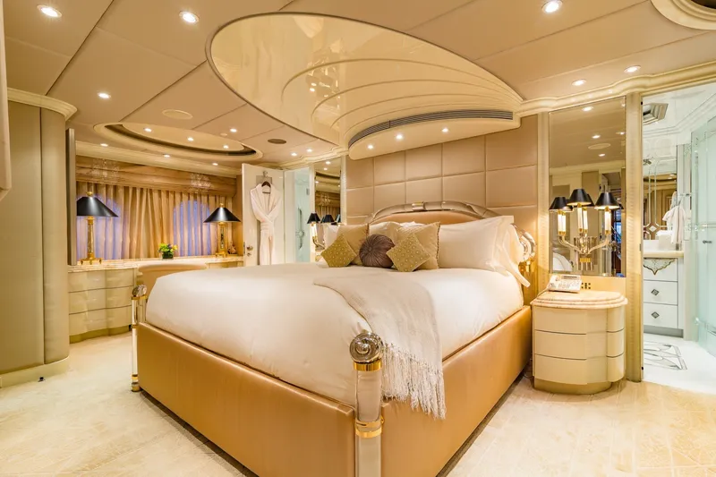 Slide: The Image of Luxurious bedroom interior on a 2002 Christensen Trideck yacht, featuring elegant decor and ambient lighting. - 15