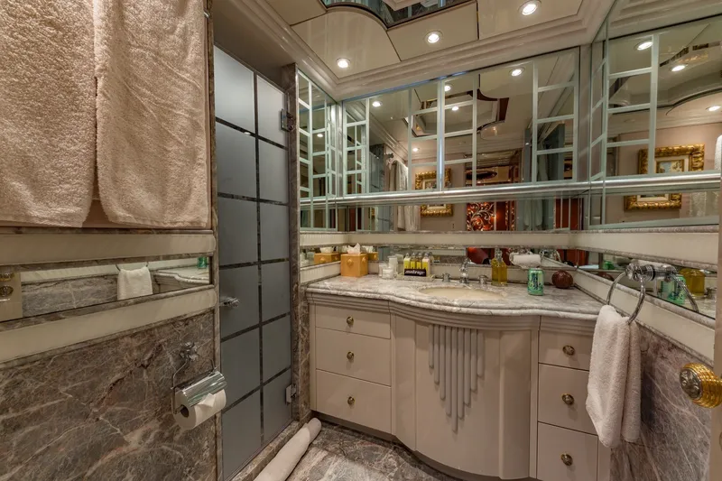 Slide: The Image of Luxurious bathroom interior on 2002 Christensen Trideck yacht, featuring marble and mirrored accents. - 36