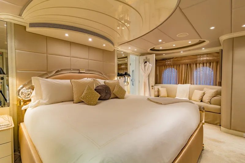 Slide: The Image of Luxurious bedroom interior on 2002 Christensen Trideck yacht, featuring elegant decor and plush bedding. - 16