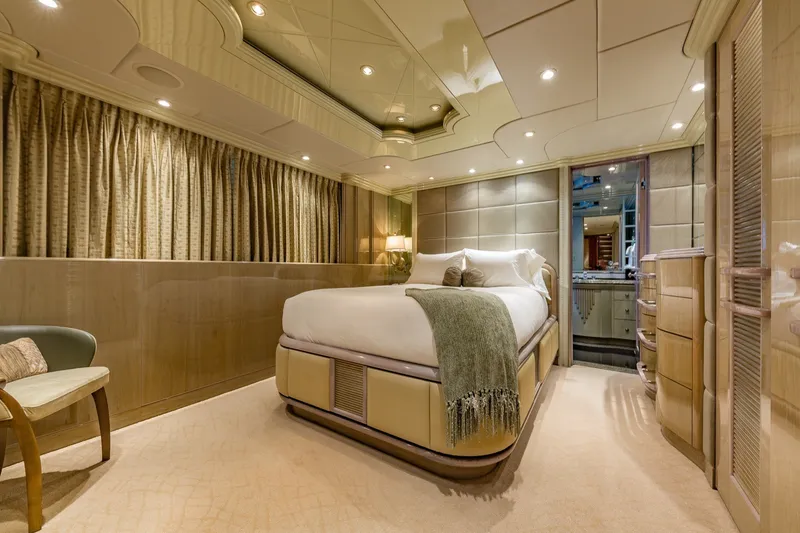 Slide: The Image of Luxurious bedroom interior on 2002 Christensen Trideck yacht, featuring elegant decor and ambient lighting. - 26