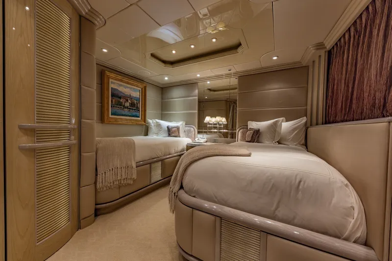 Slide: The Image of Luxurious bedroom interior on a 2002 Christensen Trideck yacht, featuring elegant twin beds and soft lighting. - 34