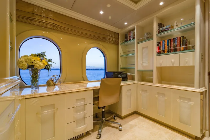 Slide: The Image of Luxurious yacht office interior with ocean view, featuring elegant cabinetry and bookshelves. - 18
