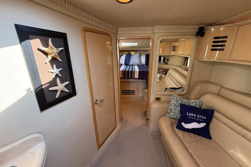 Slide: The Image of Interior of 2002 Sea Ray Sundancer 460 yacht with cozy seating and nautical decor. - 50