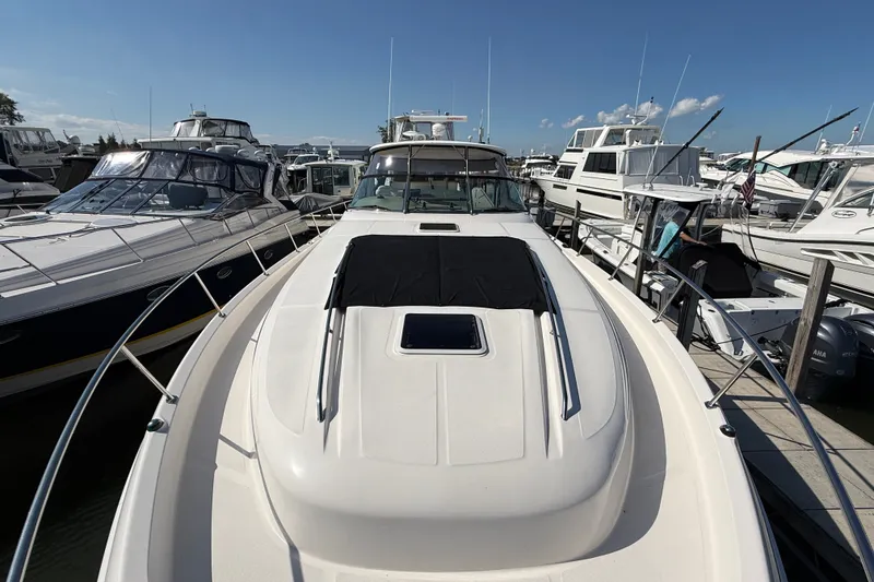 Slide: The Image of 2002 Sea Ray Sundancer 460 yacht docked among other boats on a sunny day. - 11