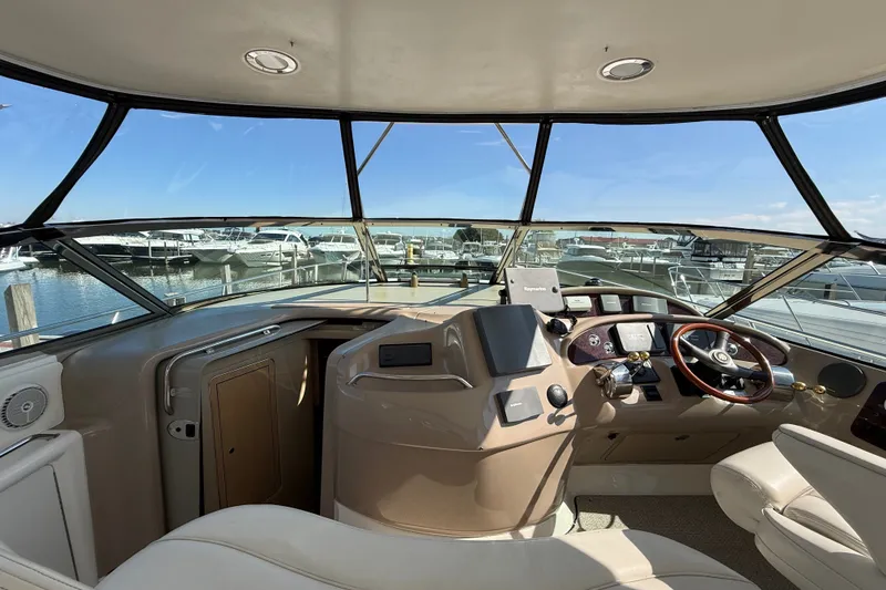 Slide: The Image of Interior view of 2002 Sea Ray Sundancer 460 yacht cockpit with marina background. - 26