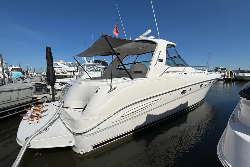Slide: The Image of 2002 Sea Ray Sundancer 460 yacht docked at marina under clear blue sky. - 8