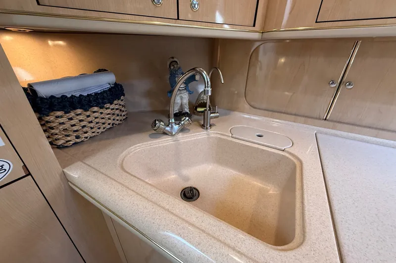 Slide: The Image of Luxurious kitchen sink area in a 2002 Sea Ray Sundancer 460 yacht. - 43