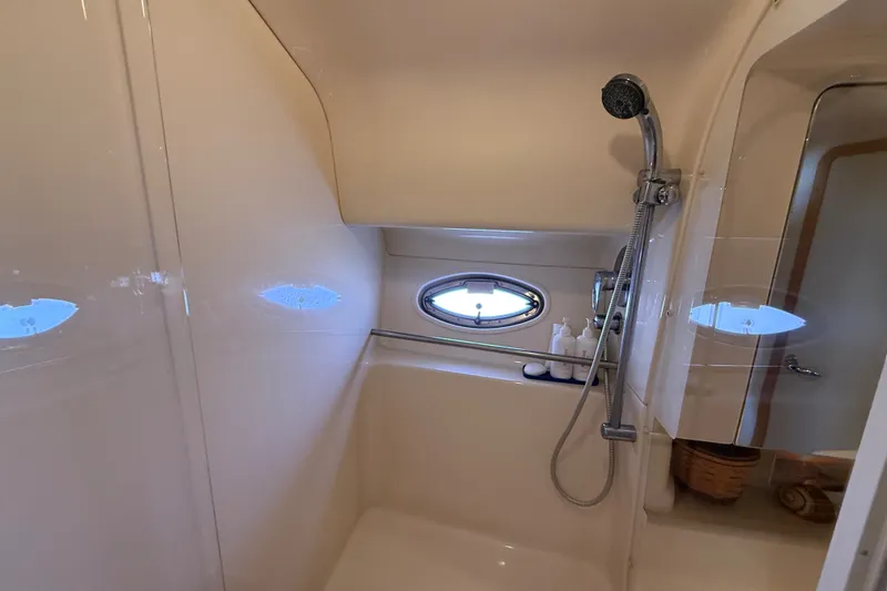 Slide: The Image of Bathroom interior of 2002 Sea Ray Sundancer 460 yacht with shower and porthole window. - 63