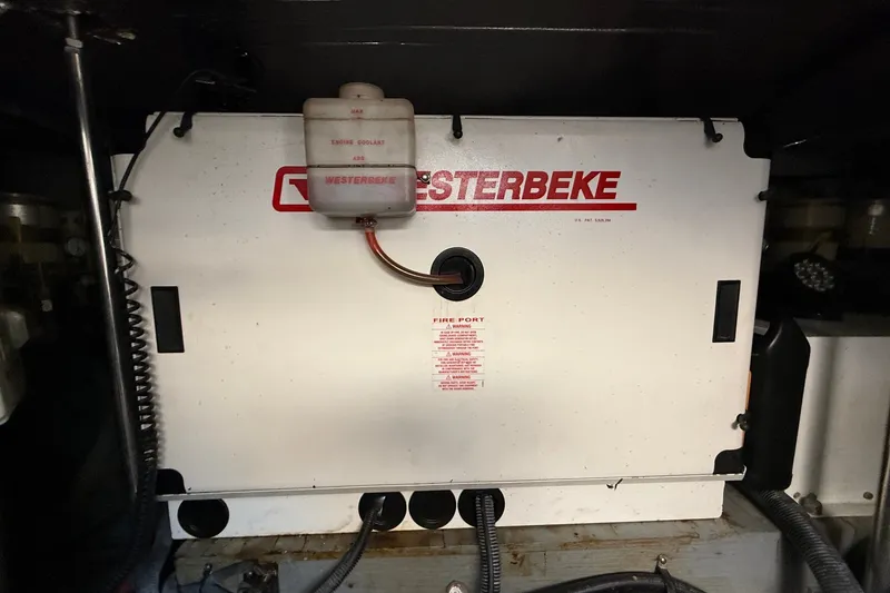 Slide: The Image of Westerbeke generator in 2002 Sea Ray Sundancer 460 engine room, showing coolant tank and wiring. - 83