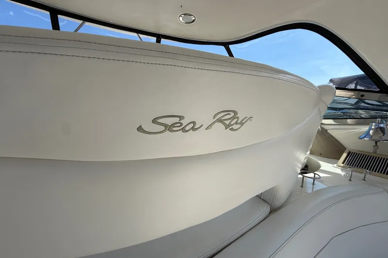Slide: The Image of Interior view of a 2002 Sea Ray Sundancer 460 yacht with logo on white seating. - 17