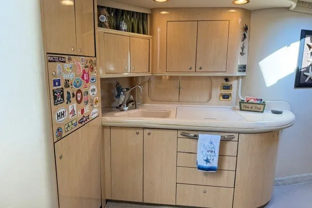 Slide: The Image of 2002 Sea Ray Sundancer 460 yacht kitchen with light wood cabinets and countertop. - 41
