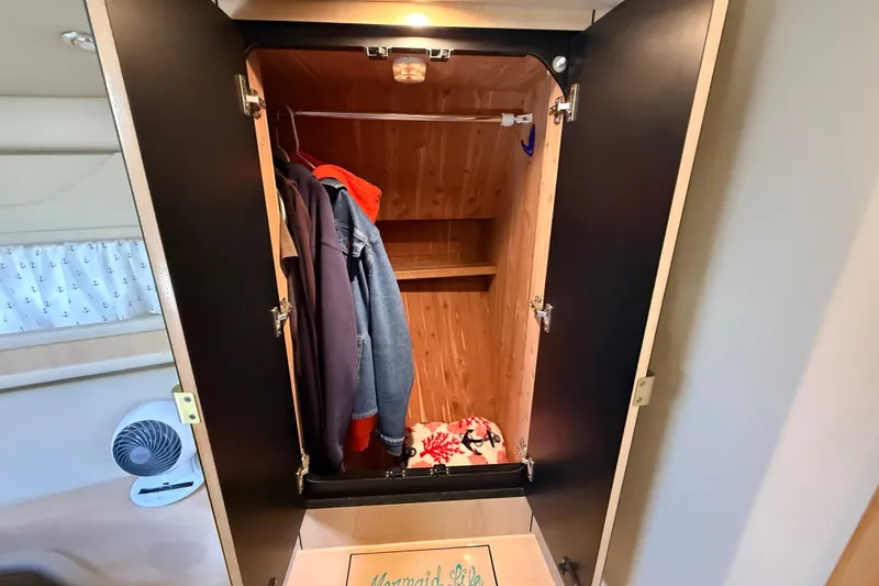 Slide: The Image of Open closet in 2002 Sea Ray Sundancer 460 with hanging clothes and shelf. - 57