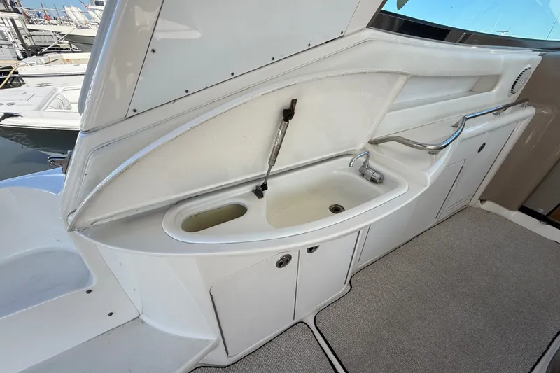 Slide: The Image of 2002 Sea Ray Sundancer 460 yacht sink area with storage compartments. - 22