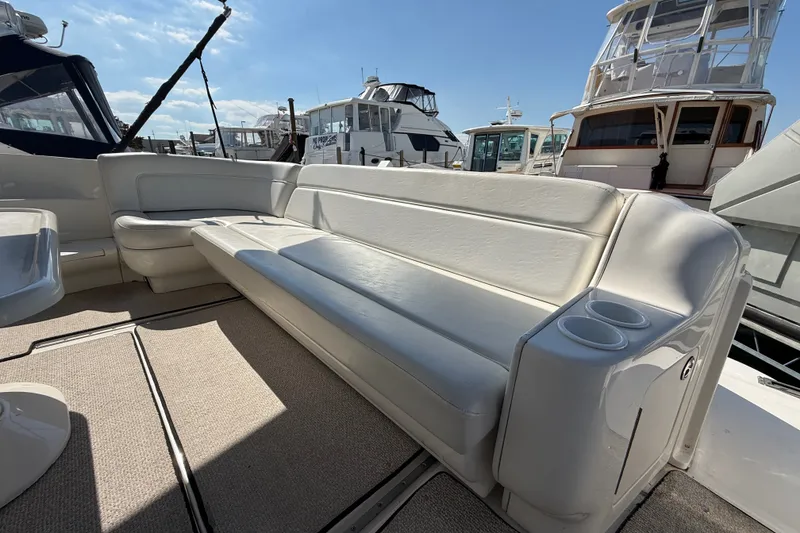 Slide: The Image of Luxurious seating area on a 2002 Sea Ray Sundancer 460 yacht, docked at a marina. - 15