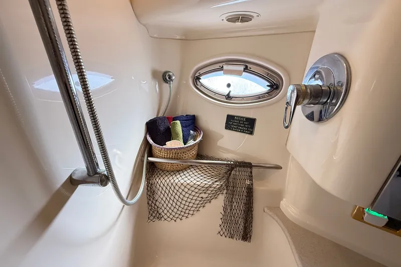 Slide: The Image of Shower area in 2002 Sea Ray Sundancer 460 yacht with porthole and storage basket. - 74