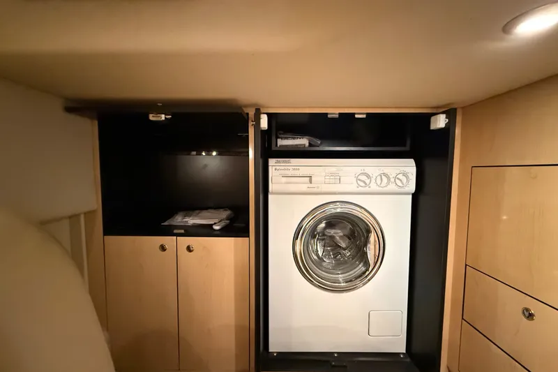 Slide: The Image of Laundry area inside 2002 Sea Ray Sundancer 460 yacht with washer and storage cabinets. - 70