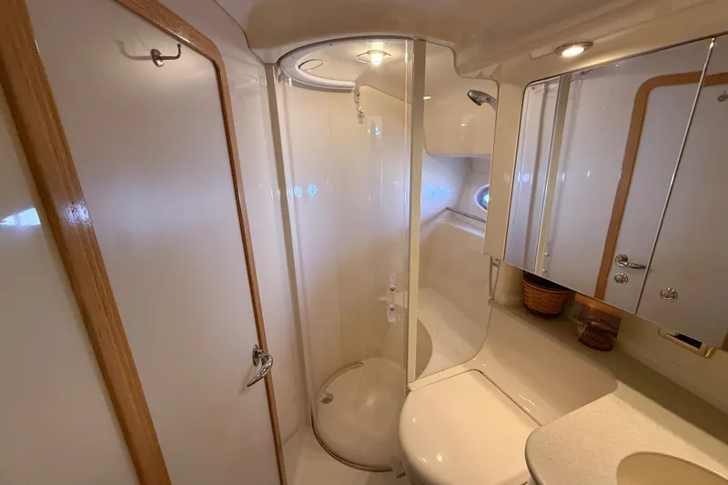 Slide: The Image of Luxurious bathroom in 2002 Sea Ray Sundancer 460 yacht, featuring shower and vanity. - 62