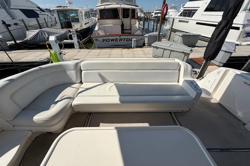 Slide: The Image of 2002 Sea Ray Sundancer 460 yacht with white seating at marina dock. - 19