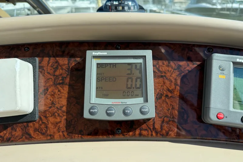 Slide: The Image of Raytheon marine display on 2002 Sea Ray Sundancer 460 dashboard, showing depth and speed. - 36
