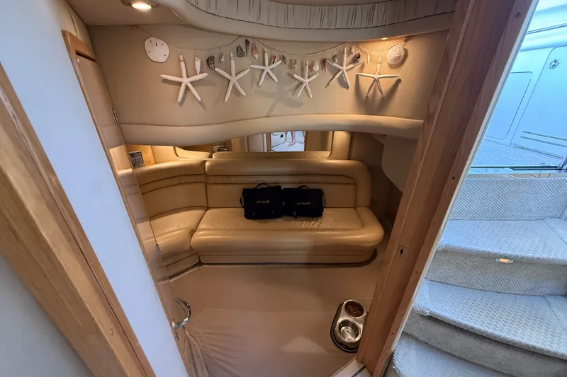 Slide: The Image of Interior of 2002 Sea Ray Sundancer 460 yacht with beige seating and starfish decor. - 64