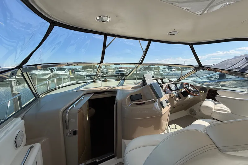 Slide: The Image of Interior view of 2002 Sea Ray Sundancer 460 yacht cockpit with marina background. - 25