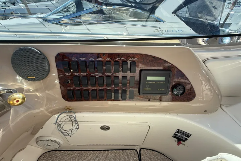 Slide: The Image of Control panel of a 2002 Sea Ray Sundancer 460 yacht with switches and system monitor. - 37
