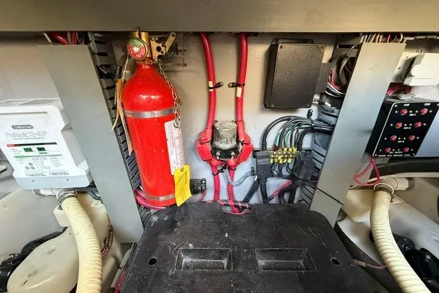 Slide: The Image of Engine room of a 2002 Sea Ray Sundancer 460 with fire extinguisher and wiring. - 87