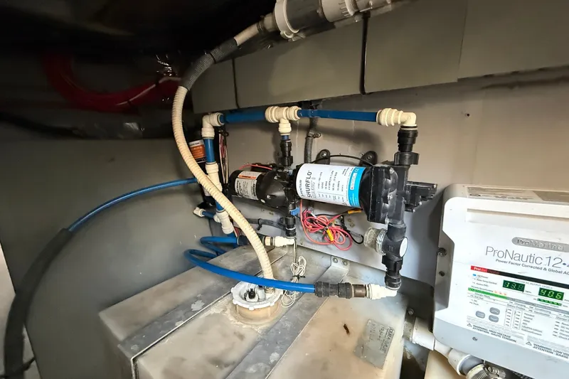Slide: The Image of Engine room of a 2002 Sea Ray Sundancer 460 with water pump and ProNautic charger. - 86