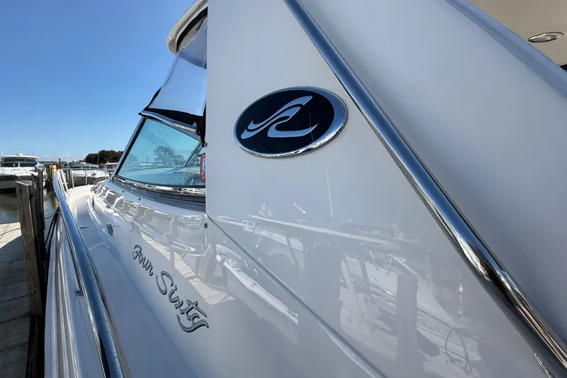 Slide: The Image of 2002 Sea Ray Sundancer 460 yacht docked, showcasing sleek design and logo. - 3