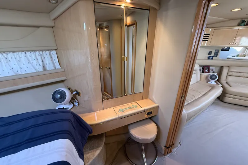 Slide: The Image of Interior of 2002 Sea Ray Sundancer 460 yacht, featuring elegant seating and vanity area. - 52