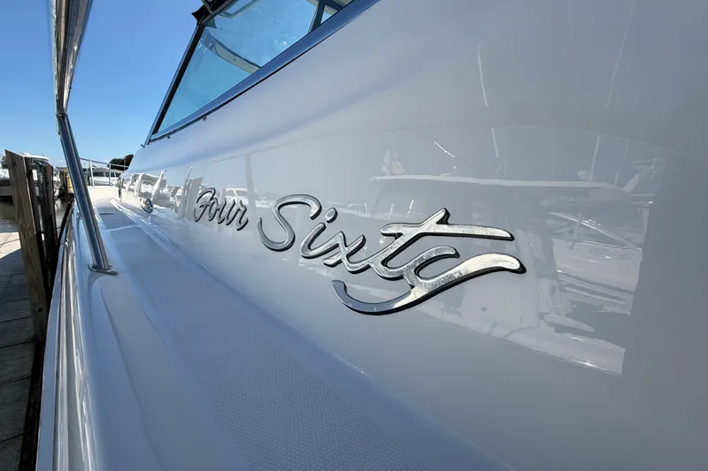 Slide: The Image of 2002 Sea Ray Sundancer 460 yacht with "Four Sixty" emblem, docked under clear blue sky. - 4