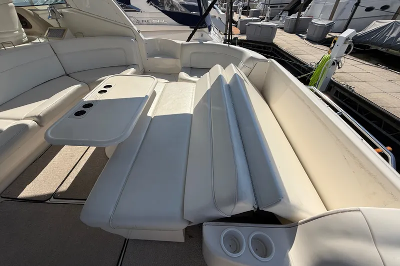 Slide: The Image of Luxurious seating area on a 2002 Sea Ray Sundancer 460 yacht with cup holders and table. - 76