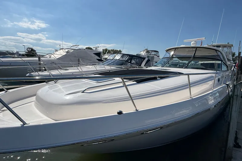 Slide: The Image of 2002 Sea Ray Sundancer 460 yacht docked under clear blue sky. - 6