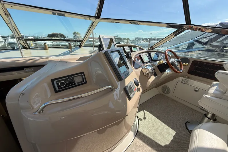 Slide: The Image of Helm of 2002 Sea Ray Sundancer 460 yacht with modern navigation equipment and leather seating. - 28