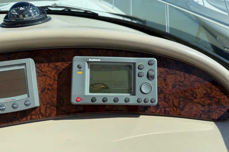 Slide: The Image of Dashboard of a 2002 Sea Ray Sundancer 460 with navigation instruments and compass. - 34