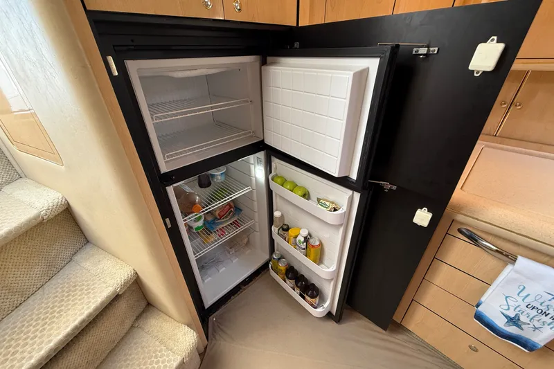 Slide: The Image of Open refrigerator in 2002 Sea Ray Sundancer 460 yacht, stocked with beverages and fruits. - 44