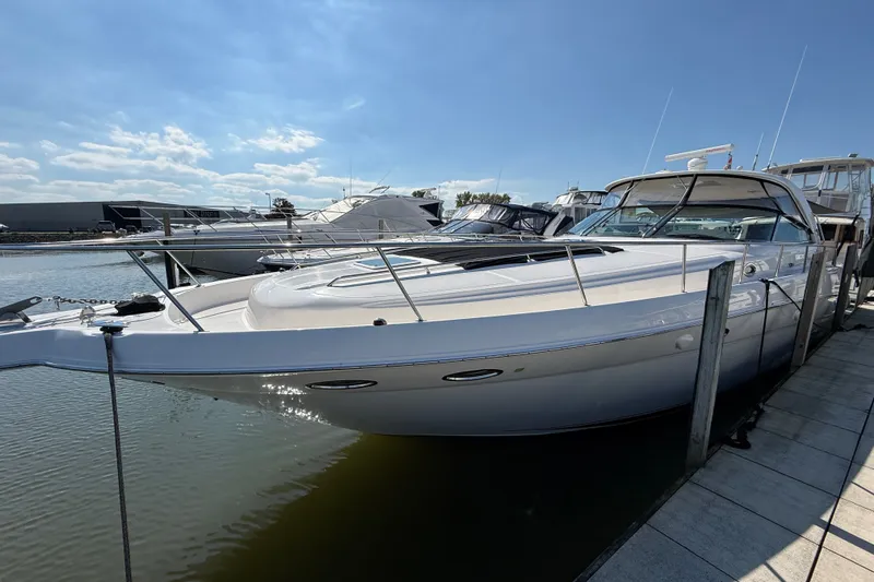 Slide: The Image of 2002 Sea Ray Sundancer 460 yacht docked at marina under clear blue sky. - 5