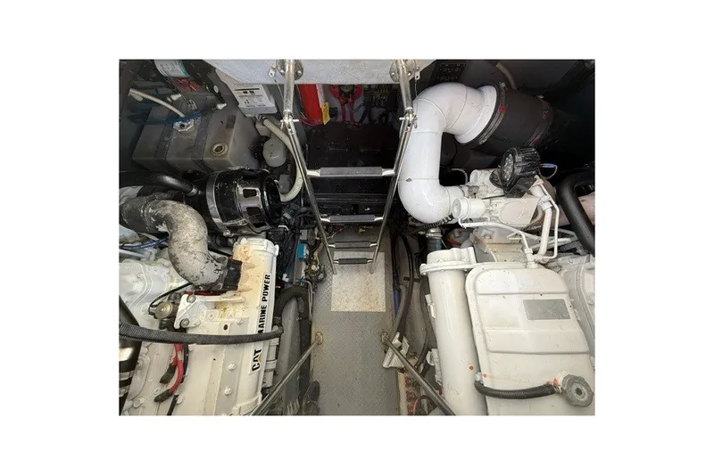 Slide: The Image of Engine room of a 2002 Sea Ray Sundancer 460, showcasing marine power components. - 77