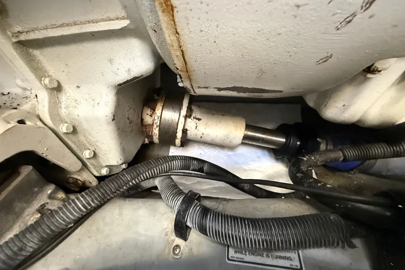 Slide: The Image of Engine compartment of a 2002 Sea Ray Sundancer 460, showing mechanical components and wiring. - 81