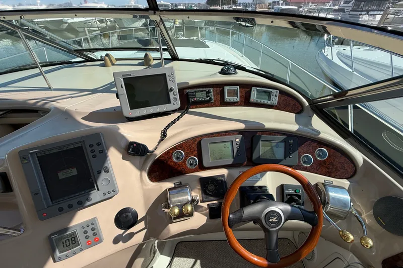 Slide: The Image of Cockpit of 2002 Sea Ray Sundancer 460 with navigation instruments and steering wheel. - 29