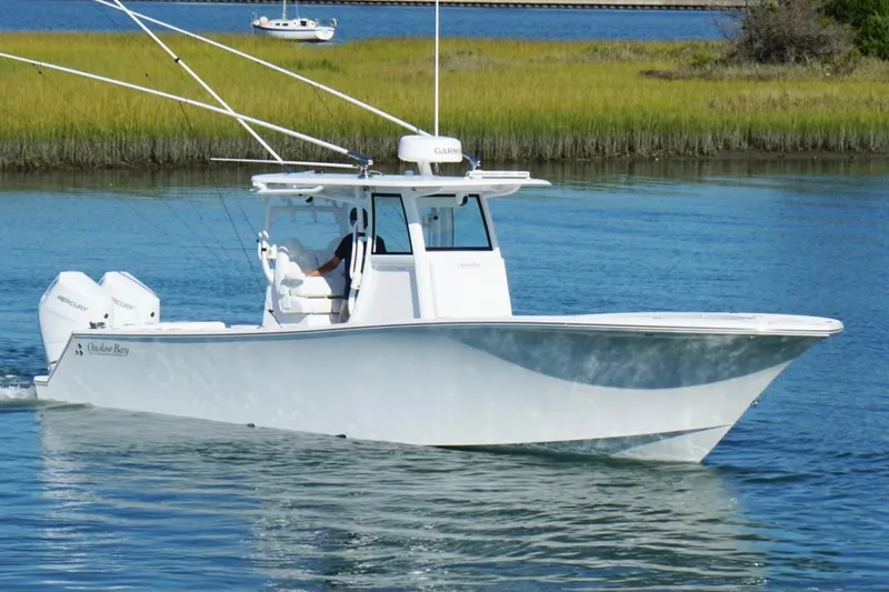Slide: The Image of 2026 Onslow Bay 33 Tournament Edition boat cruising on calm water. - 2
