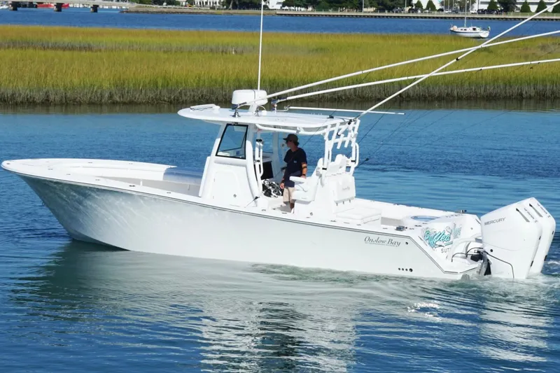 Slide: The Image of 2026 Onslow Bay 33 Tournament Edition boat cruising on a calm waterway. - 3