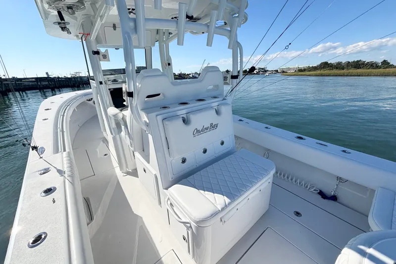 Slide: The Image of 2026 Onslow Bay 33 Tournament Edition boat on calm water, showcasing sleek design and spacious deck. - 15